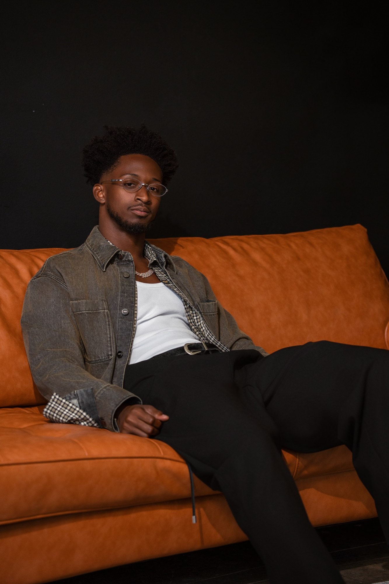 Editorial portrait of a man seated on a sofa